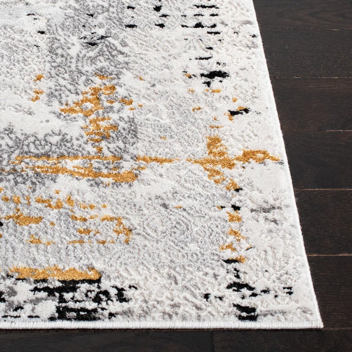 A close-up of the Acosta Rug, featuring a rectangular shape and an abstract design in white, gray, black, and yellow hues, displayed on a dark wooden floor.