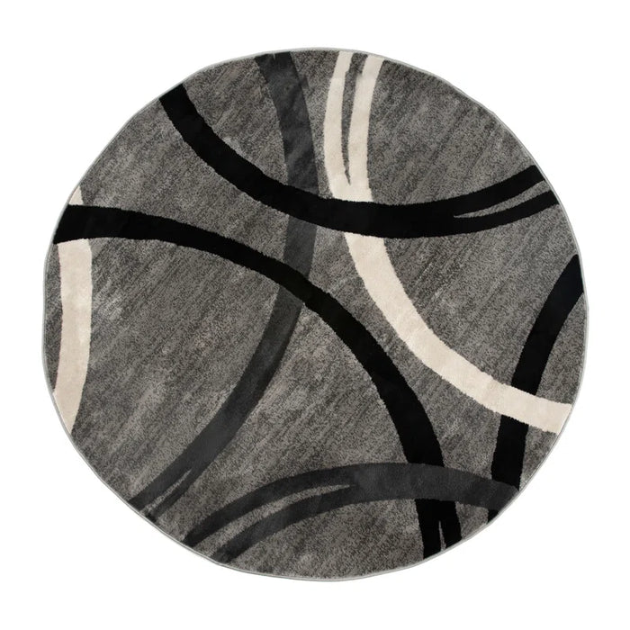 The Devonshire Abstract Gray/Black/Ivory Area Rug features a round design with abstract curved lines in black, ivory, and dark gray against a textured gray background.