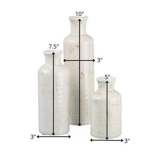 Three white ceramic vases of varying heights and widths are shown. The tallest vase is 10 inches high and 3 inches wide, the medium vase is 7.5 inches high and 3 inches wide, and the shortest vase is 5 inches high and 3 inches wide. This versatile multi-purpose Baer Ceramic Table Vase Set of 3 by Primrue makes perfect home décor pieces.