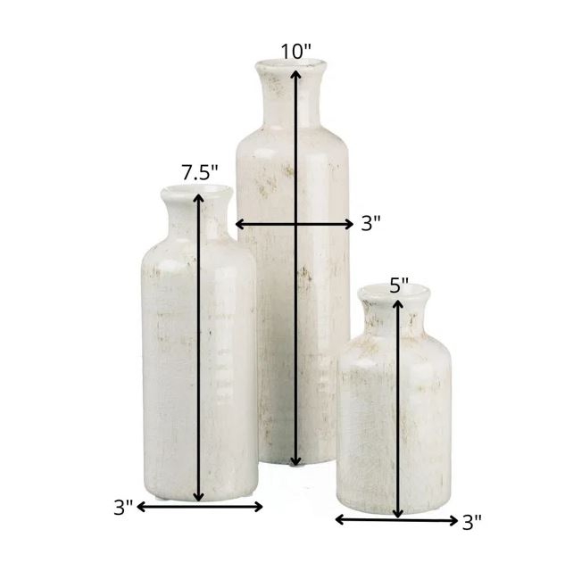 Three white ceramic vases of varying heights and widths are shown. The tallest vase is 10 inches high and 3 inches wide, the medium vase is 7.5 inches high and 3 inches wide, and the shortest vase is 5 inches high and 3 inches wide. This versatile multi-purpose Baer Ceramic Table Vase Set of 3 by Primrue makes perfect home décor pieces.