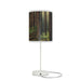 A table lamp named "Wooded Forest" featuring a cylindrical shade with tall trees and lush greenery.