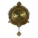 Decorative wall clock with gold finish and intricate design on a white background