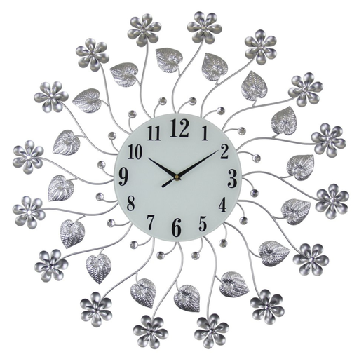 Decorative wall clock with floral and leaf designs on a white background