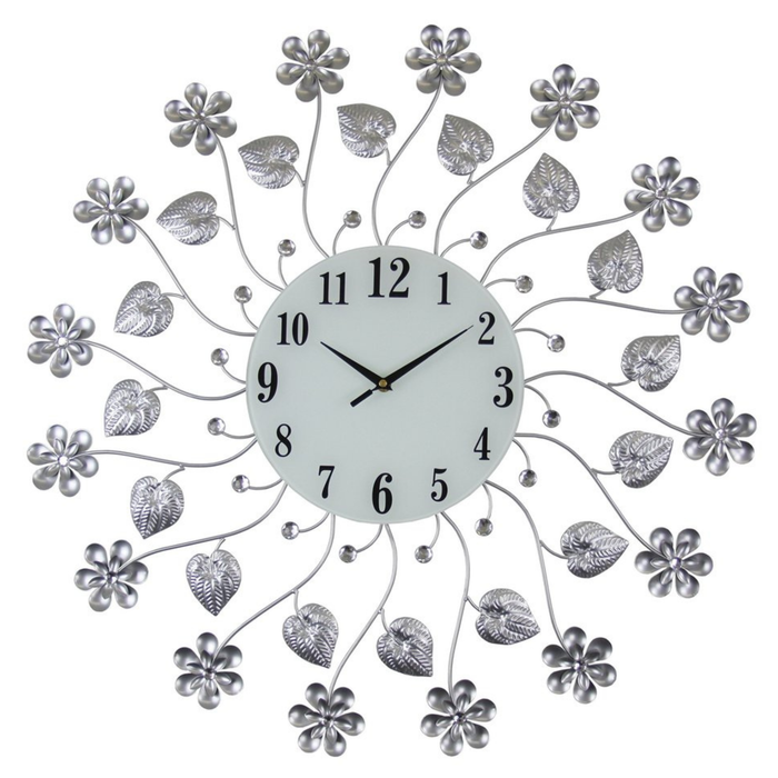 Decorative wall clock with floral and leaf designs on a white background