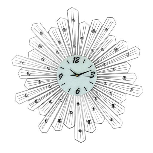 Decorative wall clock with sunburst design and gemstone accents on a white background