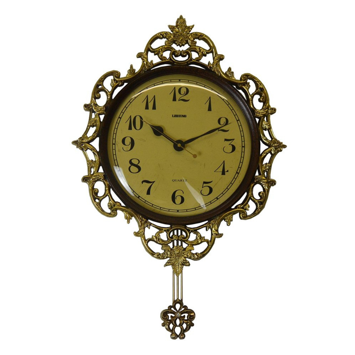 Decorative wall clock with gold frame and black hands on a white background