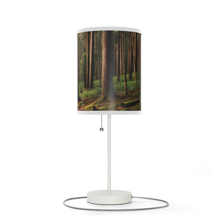 The Wooded Forest Decorative Table Lamp features a shade with tall trees and a lush green forest floor.