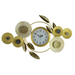 Decorative wall clock with gold floral design on a white background