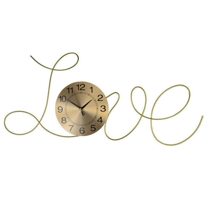 Decorative wall clock with gold spiral design on a white background
