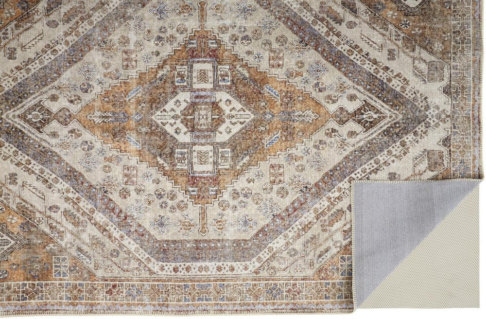 Patterned rug with geometric design in brown, beige, and gray colors.