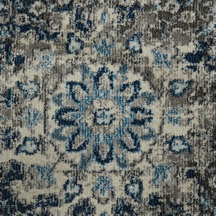Close-up of a textured rug with a pattern of blue and beige colors.