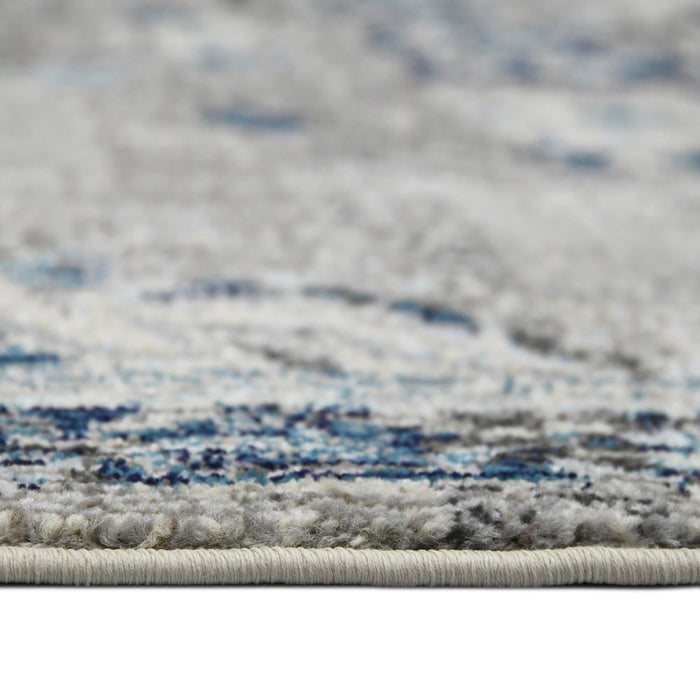 Close-up of a textured rug with blue and gray patterns