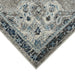 Close-up of a patterned rug with blue and gray colors on a white background