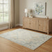 Wooden sideboard in a room with a decorative rug and wall art.
