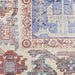 Close-up of a patterned rug with intricate designs in blue, red, and beige.