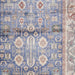 Patterned rug with blue, beige, and red colors