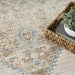 Patterned rug with a woven basket and plant on a light background