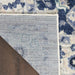 Close-up of a textured rug with a geometric pattern on a wooden floor.
