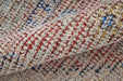 Close-up of a textured fabric with red, blue, and beige pattern