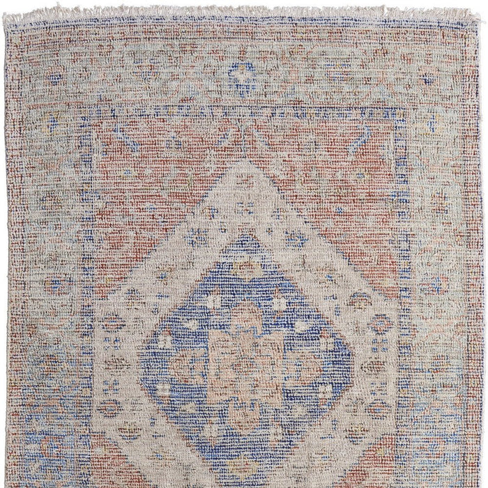 Patterned rug with blue and beige colors on a white background