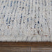 Close-up of a textured rug with a mix of colors on a wooden floor.