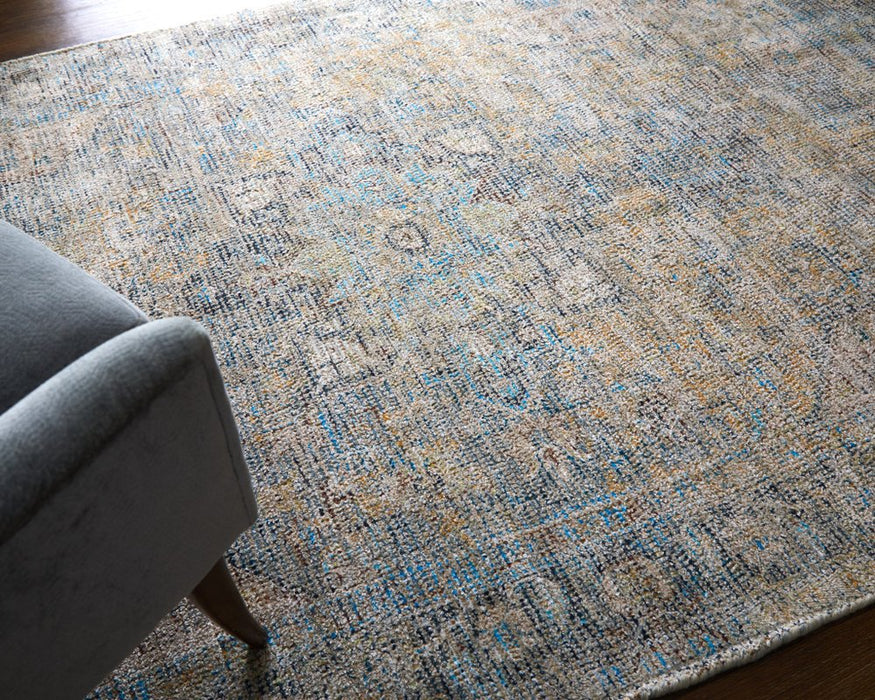 Patterned area rug on a wooden floor with a gray chair partially visible.