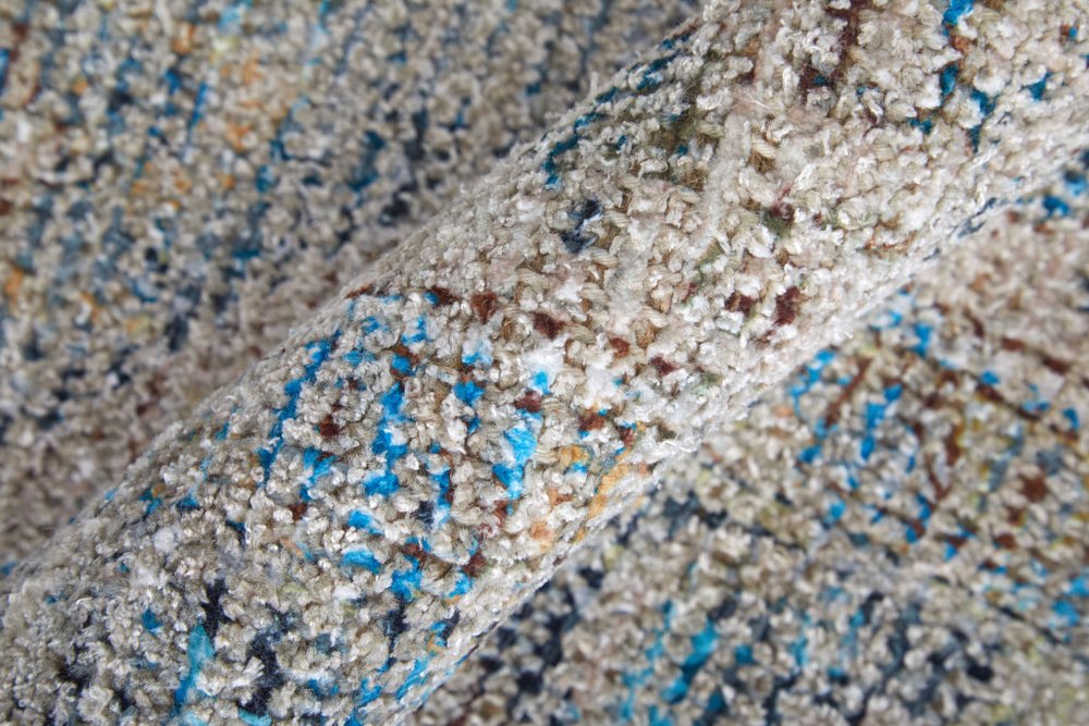 Close-up of sand with blue specks on a beach