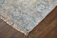 Textured area rug with fringes on a wooden floor