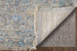 Textured rug with a close-up of the back showing carpet pad on a wooden floor.