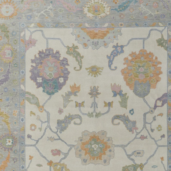 Decorative rug with floral and paisley patterns in pastel colors on a light background