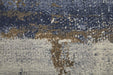 Textured rug with a mix of blue, brown, and beige colors.