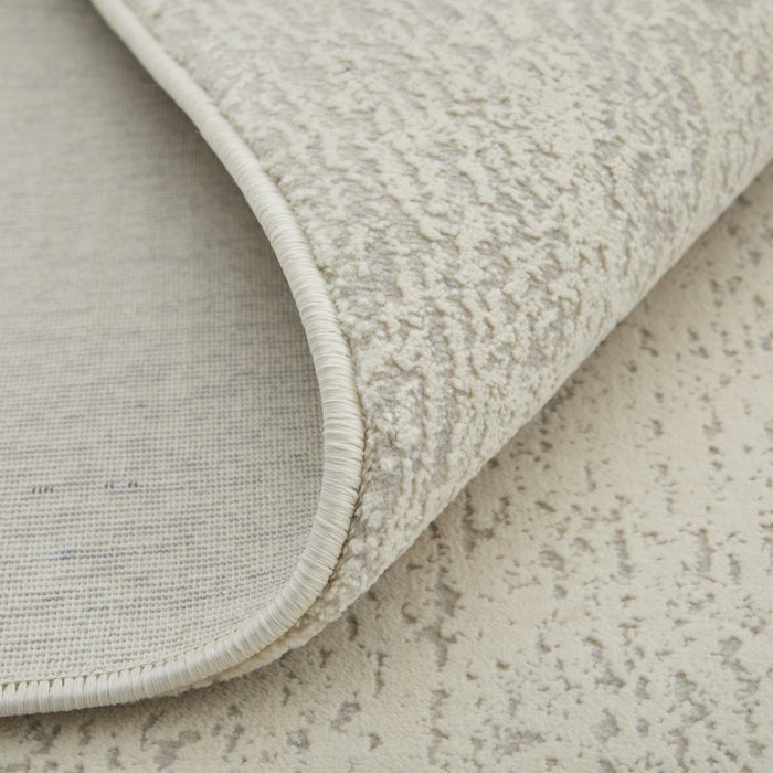 Close-up of a textured beige rug on a matching surface