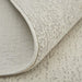 Close-up of a textured beige rug on a matching surface