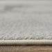Close-up of a textured gray rug on a wooden floor