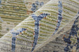 Close-up of a patterned rug with blue, green, and beige colors.