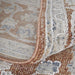 Close-up of a patterned rug with brown, beige, and blue colors.