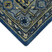 Close-up of a blue and gold patterned rug corner