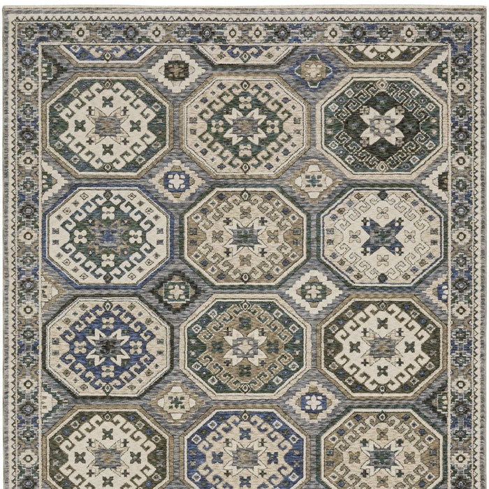 Geometric patterned rug with hexagonal designs in blue, beige, and gray.