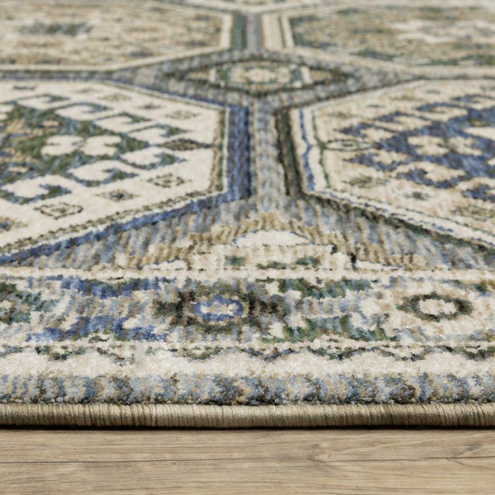 Close-up of a patterned rug with blue and beige colors on a wooden floor.