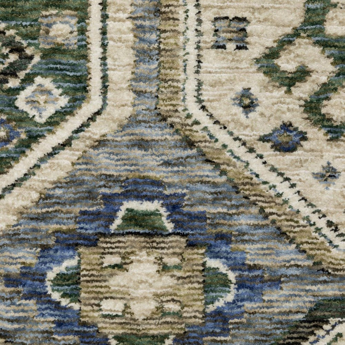 Close-up of a patterned rug with blue, beige, and green colors.