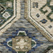 Close-up of a patterned rug with blue, beige, and green colors.