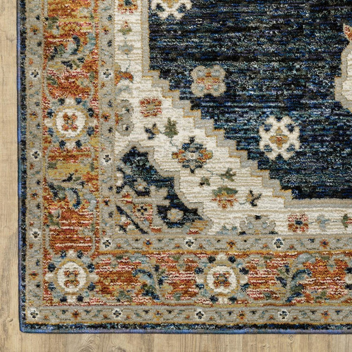 Close-up of a patterned rug with multicolor design on a wooden floor.