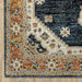 Close-up of a patterned rug with multicolor design on a wooden floor.