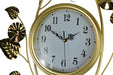 Gold-framed wall clock with decorative leaves on a white background