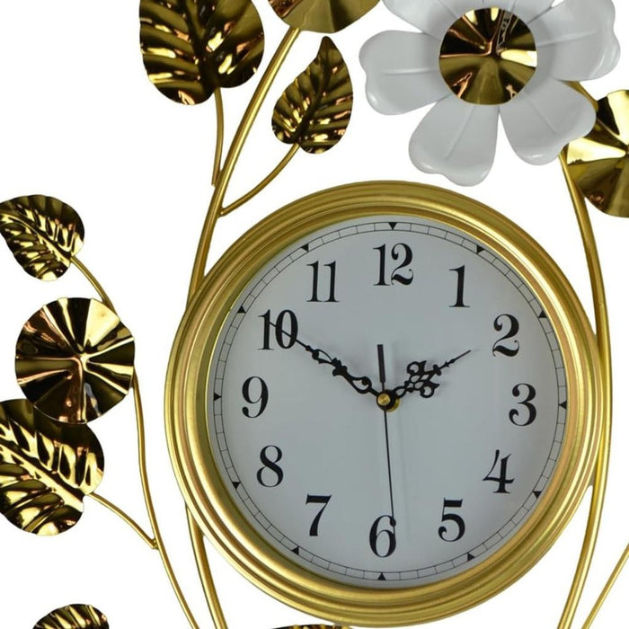 Decorative wall clock with gold leaves and flowers on a white background