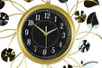 Decorative wall clock with gold frame and black face on a white background