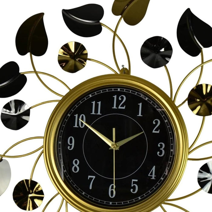 Decorative wall clock with gold and black design on a white background