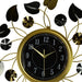 Decorative wall clock with gold and black design on a white background