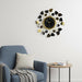 Decorative wall clock with leaf design in a living room setting