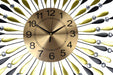 Gold clock with black numbers on a decorative background with yellow and black shapes